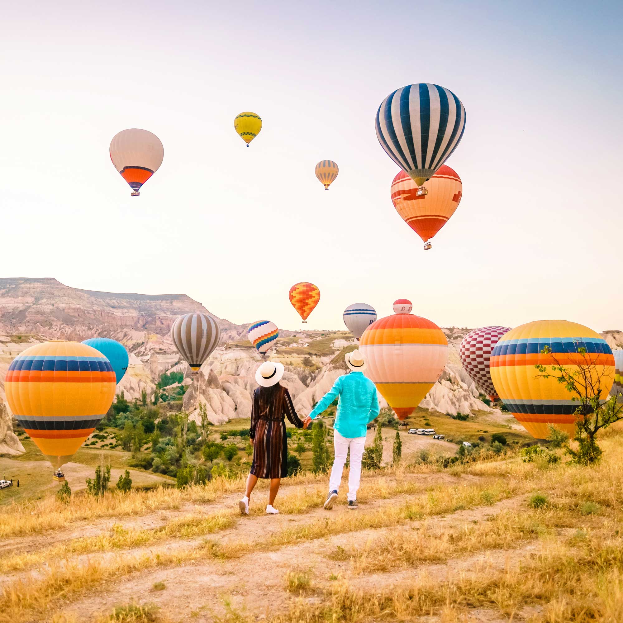 A couple contemplating Hot Air Balloons in Cappadocia A couple contemplating Hot Air Balloons in Cappadocia